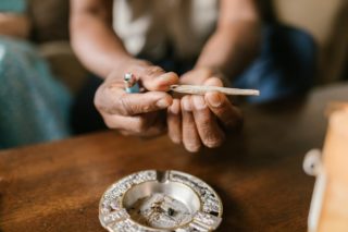 Close Up Photo of Person Holding Joint